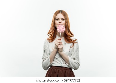 Brunette on a white background with a lollipop