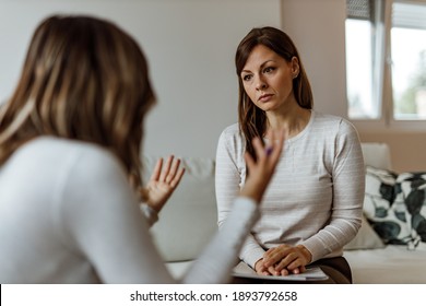 Brunette psychologist listening her patient. - Shutterstock ID 1893792658