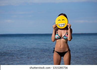 Brunette Sexy Woman With Smiley Face Mask, Bikini Party At The Beach Coronavirus Free