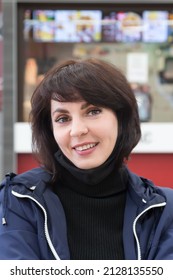 A Brunette Woman Blue Jacket In A Shopping Center Cafe.