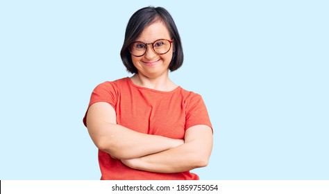 Brunette woman with down syndrome wearing casual clothes and glasses happy face smiling with crossed arms looking at the camera. positive person.  - Shutterstock ID 1859755054