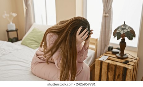 Brunette woman feeling stressed in a cozy bedroom setting with vintage lamp and rustic nightstand. - Powered by Shutterstock