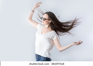Brunette woman with fluttering hair with wind.