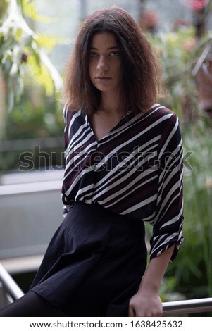 Similar – young beautiful lady posing in the living room next to a window