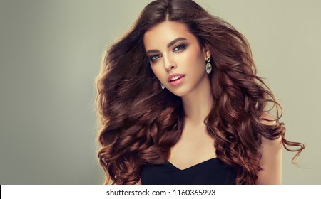 Brunette  woman  with long , healthy and   shiny curly hair .  Beautiful  model girl  with wavy hairstyle   .Care and beauty products  - Shutterstock ID 1160365993