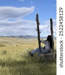 A brunette woman looking out over Pleasant Valley in Yellowstone National Park