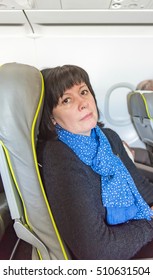 Brunette Woman Of Middle Age In The Cabin Of The Aircraft Seat