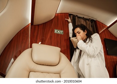 Brunette Woman, Passenger Of A Business Class Plane In A White Suit Experiences Vestibular Disorders, Aerophobia And Nausea While Flying On An Airplane