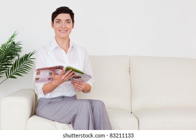 Brunette Woman Reading A Magazine In A Waiting Room