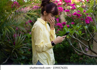 A Brunette Woman Is Reading Sad News On The Mobile Smartphone. SMS Or E-mail. Anxiety. Emotions. Technology Obsession. 