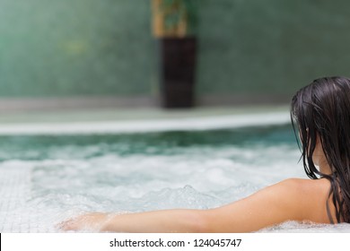 Brunette woman relaxing in jacuzzi
