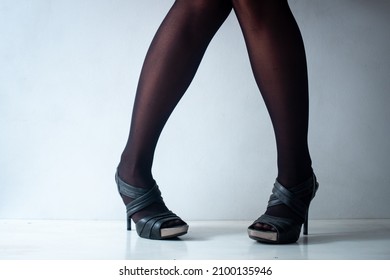 A Brunette Woman With Short Legs And Knees Together Is Standing On A In White Background