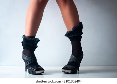 A Brunette Woman With Short Legs And Knees Together Is Standing On A In White Background