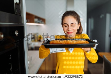 Brunette woman, spending time at kitchen, making dinner.