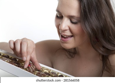 Brunette Woman Takes A Chocolate Candy From The Candy Box