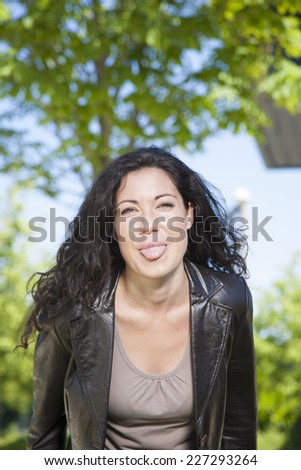 brunette woman teasing at exterior background