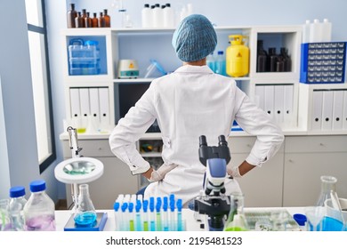 Brunette Woman Working At Scientist Laboratory Standing Backwards Looking Away With Arms On Body 