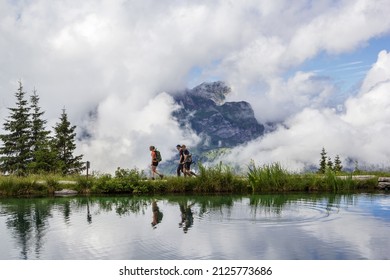 Brunni, Switzerland - August 06. 2021: People Hiking Along A Mountain Lake Haerzlisee. The Area Above The Engelberg In Titlis Region Is A Popular Recreation Place Offering Diverse Outdoor Activities.