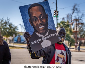 Brunswick, Georgia USA - January 18, 2021: Marcus Arbery, Sr., father of Ahmaud Arbery, carries a portrait of his son in the Rev. Martin Luther King, Jr. Day Parade.