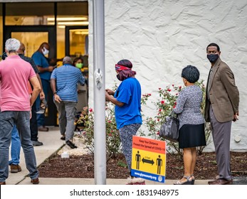 BRUNSWICK, GEORGIA / USA - October 12, 2020: The first morning of early voting in Georgia began with lines at the Brunswick polling station and candidates' boosters on the street.