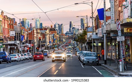 Brunswick, Victoria, Australia, June 12th 2021: A Very Busy Sydney Road In Brunswick In The Early Evening Light With The Melbourne City Skyline In The Background.