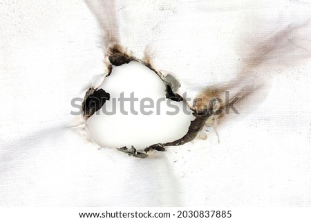 Brunt hole on white plsatic sheet isolated on white background.