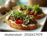 Bruschetta with cream cheese, cherry tomatoes, arugula, and pesto on toasted bread