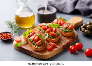 Bruschetta, Crostini With Pesto And Tomato. Grey Background. Close Up.