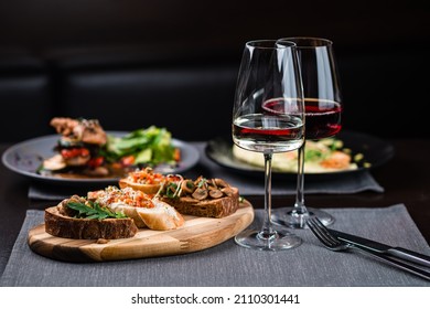 bruschetta set with parma, salmon and tuna, assorted set of bruschetta with salmon with herbs and tuna on black menu background - Powered by Shutterstock