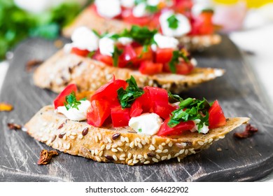 Bruschetta with tomatoes and curd cheese on whole wheat bread - Powered by Shutterstock