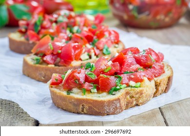 Bruschetta with tomatoes, herbs and oil on toasted garlic cheese bread - Shutterstock ID 296697692