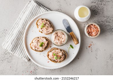 bruschetta with tuna pate, fish rillettes, sandwich on a white plate, top view