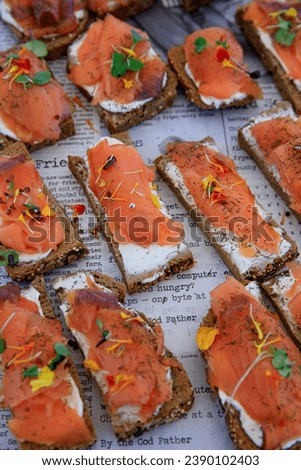 Bruschettas with salmon and cream cheese a plate with newspapers at a beachbar on Gran Canaria, Spain
