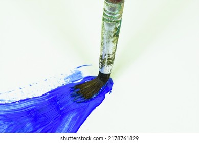 Brush With Blue Acrylic Paint On White Paper. Creative Drawing Concept.