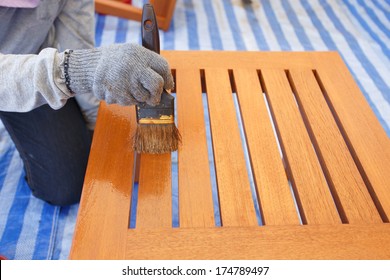 Brush In Hand And Painting On The Wooden Furniture