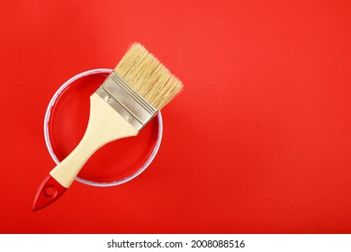 Brush Handle On Opened Cans On Red Background. Watercolor Acrylic Paint. Top View. Banner Of Renovation Concept.