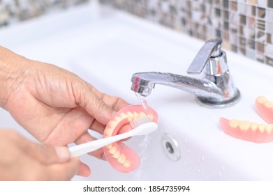 Brush Old Woman Hand To Clean Denture