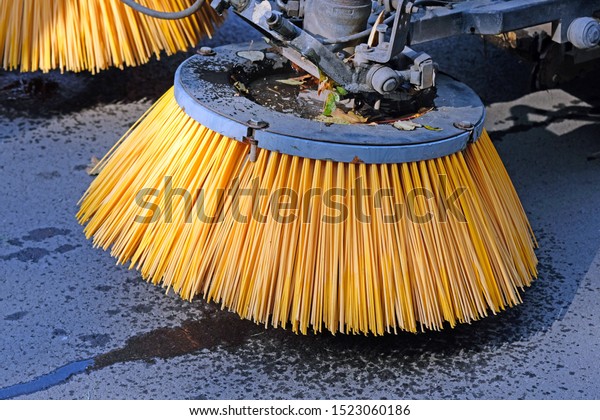 Brush on\
a machine for collecting fallen leaves. Special yellow machine\
brushes for fallen leaves that sweep and collect leaves in a city\
park. Cleaning the park from leaves in the\
fall.