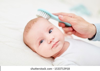 Brush Removes Dandruff From The Skin Of A Newborn Baby