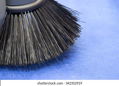 Brush Of Road Sweeper On Blue Carpet