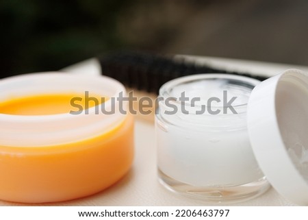 Brush and small bottle of cream, leather goods maintenance kit