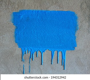 Brush strokes and paint drips on the concrete wall