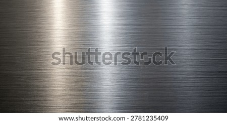 brushed metal surface with a distinct linear texture and bright light reflection, featuring a