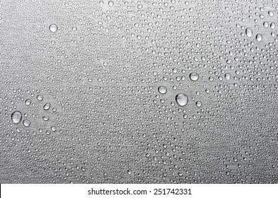 Brushed metal surface with water drops