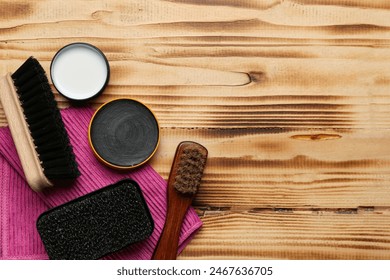 Brushes, brush, cloth and shoe polish on wooden background - Powered by Shutterstock