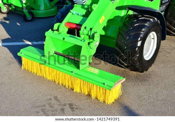 Brushes for\
cleaning the streets are fixed on the car. Special machinery.\
Machine with tassels. Car for cleaning in the city. Automatic road\
cleaning brushes. Washing sidewalks. -\
Image