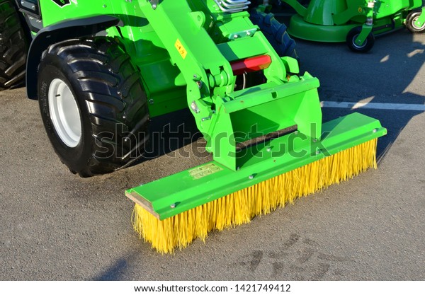 Brushes for\
cleaning the streets are fixed on the car. Special machinery.\
Machine with tassels. Car for cleaning in the city. Automatic road\
cleaning brushes. Washing sidewalks. -\
Image