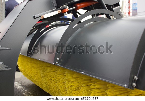 brushes for\
road cleaning on the street on a\
tractor