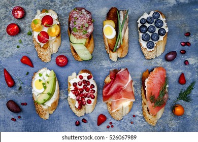 Brushetta or authentic traditional spanish tapas set for lunch table. Sharing antipasti on party or summer picnic time over blue rustic background. Top view, flat lay.
 - Shutterstock ID 526067989