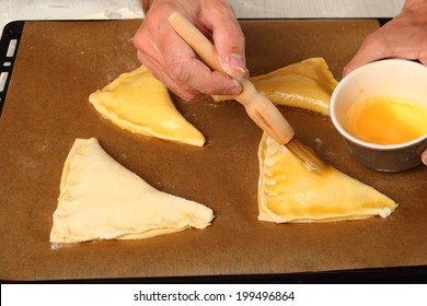 Brushing With Egg Glaze. Making Chocolate Croissants With Puff Pastry